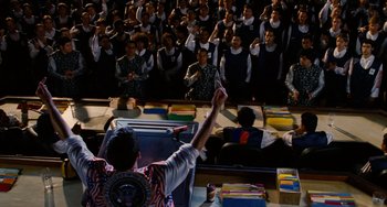 Movie still from “Idiocracy” (2006), directed by Mike Judge – A group of people standing in front of a crowd; Medium shot, High angle