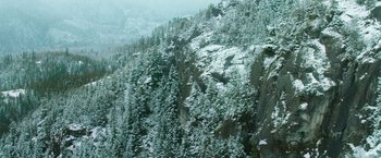 Movie still from “If I Stay” (2014), directed by R.J. Cutler – A view of a snowy mountain side with trees in the foreground; Extreme Wide shot, High angle