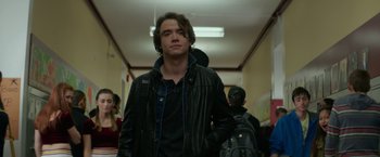 Movie still from “If I Stay” (2014), directed by R.J. Cutler – A man in a black leather jacket standing in a hallway; Medium shot, Low angle