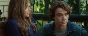 Movie still from “If I Stay” (2014), directed by R.J. Cutler – A man and a woman sitting next to each other in front of trees; Close Up shot, Over the shoulder angle