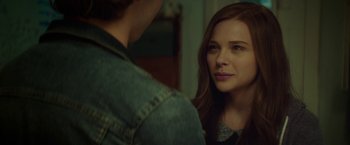 Movie still from “If I Stay” (2014), directed by R.J. Cutler – A woman looking at a man in the mirror; Close Up shot, Over the shoulder angle