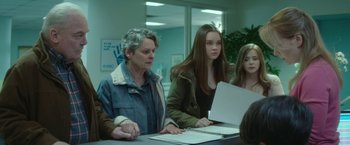 Movie still from “If I Stay” (2014), directed by R.J. Cutler – A woman and a girl sitting at a table; Medium shot, Over the shoulder angle