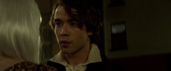 Movie still from “If I Stay” (2014), directed by R.J. Cutler – A man with curly brown hair wearing a white shirt; Close Up shot, Over the shoulder angle