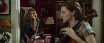 Movie still from “If I Stay” (2014), directed by R.J. Cutler – Two women sitting on a couch in a living room; Medium shot, Over the shoulder angle