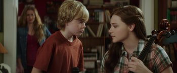 Movie still from “If I Stay” (2014), directed by R.J. Cutler – A boy and a girl looking at one another; Close Up shot, Over the shoulder angle