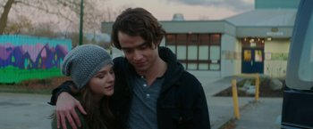 Movie still from “If I Stay” (2014), directed by R.J. Cutler – A man and a woman standing next to each other; Close Up shot, Over the shoulder angle