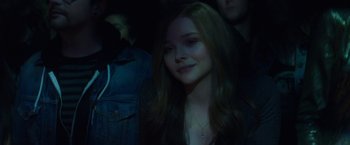 Movie still from “If I Stay” (2014), directed by R.J. Cutler – A woman with long hair is smiling for the camera; Close Up shot, High angle