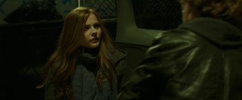 Movie still from “If I Stay” (2014), directed by R.J. Cutler – A woman sitting in the back of a vehicle; Close Up shot, Over the shoulder angle