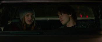 Movie still from “If I Stay” (2014), directed by R.J. Cutler – A man and a woman sitting in the back of a car; Close Up shot, Over the shoulder angle