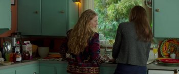 Movie still from “If I Stay” (2014), directed by R.J. Cutler – A woman standing at a counter in front of a window; Medium shot, Over the shoulder angle