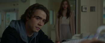 Movie still from “If I Stay” (2014), directed by R.J. Cutler – A man and a woman are standing in a room; Close Up shot, Over the shoulder angle