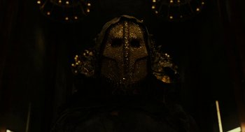 Movie still from “Immortals” (2011), directed by Tarsem Singh – The face of a person wearing a mask; Close Up shot, Low angle
