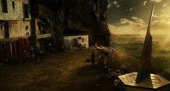 Movie still from “Immortals” (2011), directed by Tarsem Singh – A group of people standing on top of a sandy beach; Extreme Wide shot, High angle