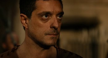 Movie still from “Immortals” (2011), directed by Tarsem Singh – A person wearing a brown shirt; Close Up shot, Over the shoulder angle