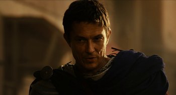 Movie still from “Immortals” (2011), directed by Tarsem Singh – A person wearing a costume; Close Up shot, Over the shoulder angle