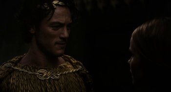 Movie still from “Immortals” (2011), directed by Tarsem Singh – A man in a costume talking to another man; Close Up shot, Over the shoulder angle