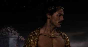 Movie still from “Immortals” (2011), directed by Tarsem Singh – A person wearing a costume; Close Up shot, Over the shoulder angle