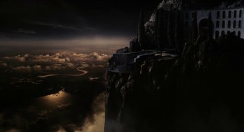 Movie still from “Immortals” (2011), directed by Tarsem Singh – An aerial view of a mountain with a sky filled with dark clouds; Extreme Wide shot, Overhead angle