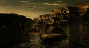 Movie still from “Immortals” (2011), directed by Tarsem Singh – A boat floating on a body of water near rocks; Extreme Wide shot, High angle