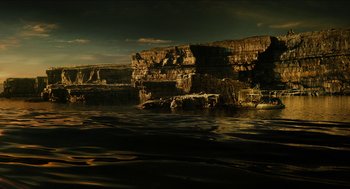 Movie still from “Immortals” (2011), directed by Tarsem Singh – A body of water near a rocky cliff side; Extreme Wide shot, High angle