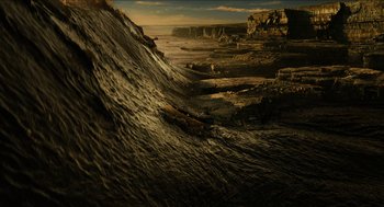Movie still from “Immortals” (2011), directed by Tarsem Singh – A view of a desert landscape with a mountain in the background; Extreme Wide shot, High angle