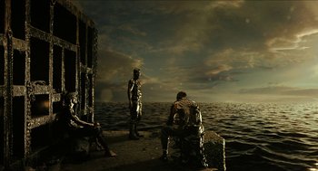 Movie still from “Immortals” (2011), directed by Tarsem Singh – A man sitting on a dock next to a body of water; Wide shot, Low angle