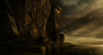 Movie still from “Immortals” (2011), directed by Tarsem Singh – A rock formation with a bird flying in the sky; Extreme Wide shot, Low angle
