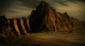 Movie still from “Immortals” (2011), directed by Tarsem Singh – An image of a desert scene with mountains in the background; Extreme Wide shot, High angle