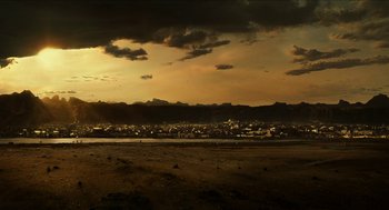 Movie still from “Immortals” (2011), directed by Tarsem Singh – A view of a city at sunset from a beach; Extreme Wide shot, Low angle
