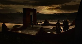 Movie still from “Immortals” (2011), directed by Tarsem Singh – Two people are sitting on a bench in front of a building; Extreme Wide shot, High angle