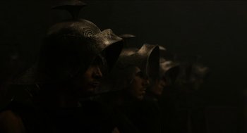Movie still from “Immortals” (2011), directed by Tarsem Singh – A group of people wearing helmets in a dark room; Close Up shot, High angle