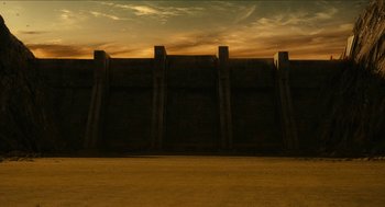 Movie still from “Immortals” (2011), directed by Tarsem Singh – An image of an empty field with a large wall in the background; Extreme Wide shot, Low angle