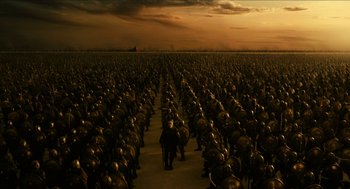 Movie still from “Immortals” (2011), directed by Tarsem Singh – A man standing in front of a large group of soldiers; Extreme Wide shot, High angle