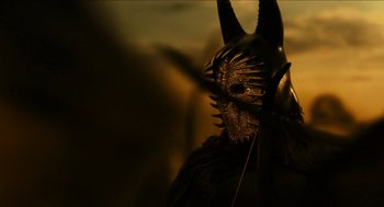 Movie still from “Immortals” (2011), directed by Tarsem Singh – A person wearing a horned mask; Extreme Close Up shot, Low angle