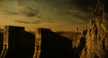 Movie still from “Immortals” (2011), directed by Tarsem Singh – A view of a wall and a building from the ground; Extreme Wide shot, Low angle