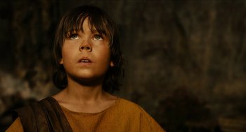 Movie still from “Immortals” (2011), directed by Tarsem Singh – A young boy looking up into the sky; Close Up shot, Low angle