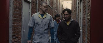 Movie still from “In Time” (2011), directed by Andrew Niccol – A group of people walking down a street; Medium shot, Low angle