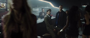 Movie still from “In Time” (2011), directed by Andrew Niccol – A group of men sitting in a room; Medium shot, Low angle