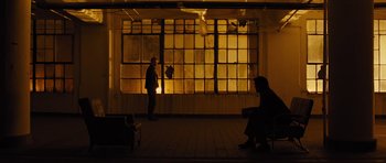 Movie still from “In Time” (2011), directed by Andrew Niccol – Two people sitting in front of a window at night; Extreme Wide shot, Over the shoulder angle