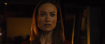 Movie still from “In Time” (2011), directed by Andrew Niccol – A person with long brown hair; Close Up shot, Over the shoulder angle