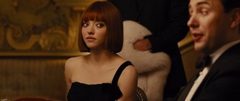 Movie still from “In Time” (2011), directed by Andrew Niccol – A woman in a black dress and a man in a black suit; Close Up shot, Over the shoulder angle