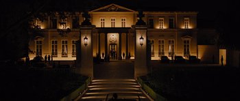 Movie still from “In Time” (2011), directed by Andrew Niccol – A large building with a clock on the front of it; Extreme Wide shot, Low angle