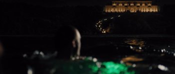 Movie still from “In Time” (2011), directed by Andrew Niccol – A man swimming in a body of water at night; Extreme Wide shot, High angle