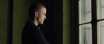 Movie still from “In Time” (2011), directed by Andrew Niccol – A young man is looking into the distance; Close Up shot, Low angle