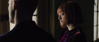 Movie still from “In Time” (2011), directed by Andrew Niccol – A woman with red hair looking at a man with red hair; Close Up shot, Low angle