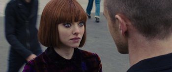 Movie still from “In Time” (2011), directed by Andrew Niccol – A woman with red hair and blue eyes talking to a man in a plaid shirt; Close Up shot, Over the shoulder angle