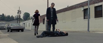 Movie still from “In Time” (2011), directed by Andrew Niccol – A man laying on the ground next to a woman; Wide shot, High angle