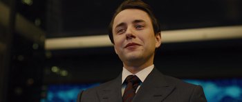 Movie still from “In Time” (2011), directed by Andrew Niccol – A person wearing a suit and tie; Close Up shot, Low angle