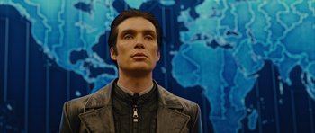 Movie still from “In Time” (2011), directed by Andrew Niccol – A person wearing a jacket with a map in the background; Close Up shot, Low angle