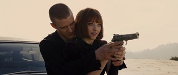 Movie still from “In Time” (2011), directed by Andrew Niccol – A man and a woman are holding a gun; Close Up shot, Over the shoulder angle